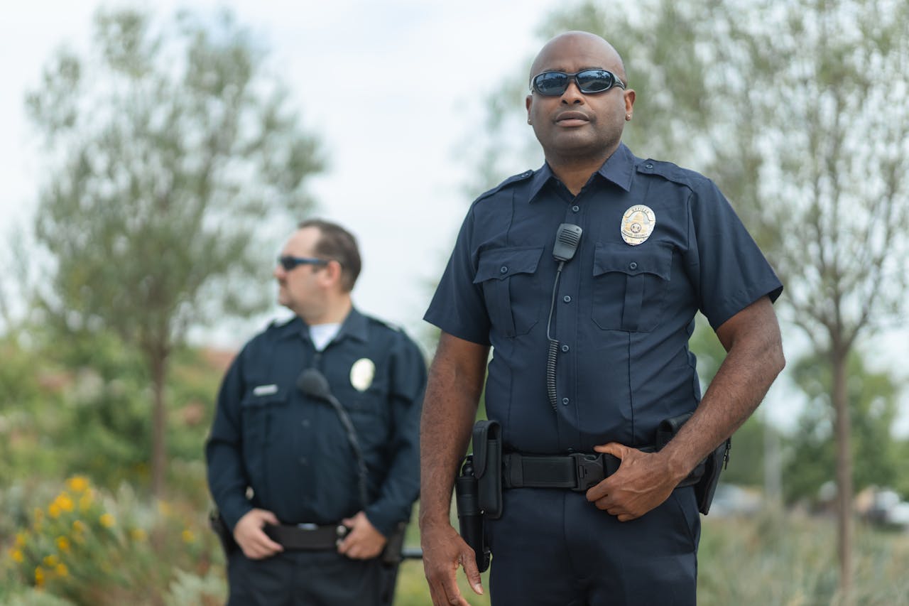 Mastering the First Impression: Your intriguing post title goes here Two police officers in uniform ensure public safety, standing confidently outside.